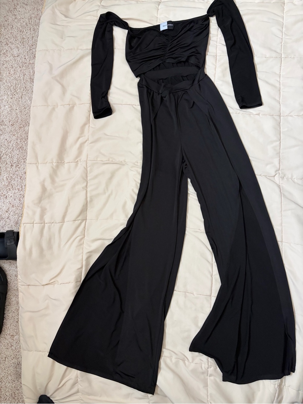 Black Wide-Leg Jumpsuit with Long Sleeves open leg.